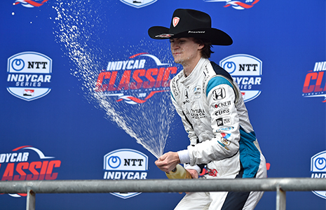 Colton Herta sprays champagne