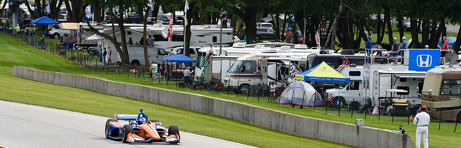 Scott Dixon drives past row of Road America campers
