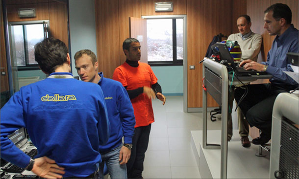 Juan Pablo Montoya chats with engineers at the Dallara simulator in Italy.