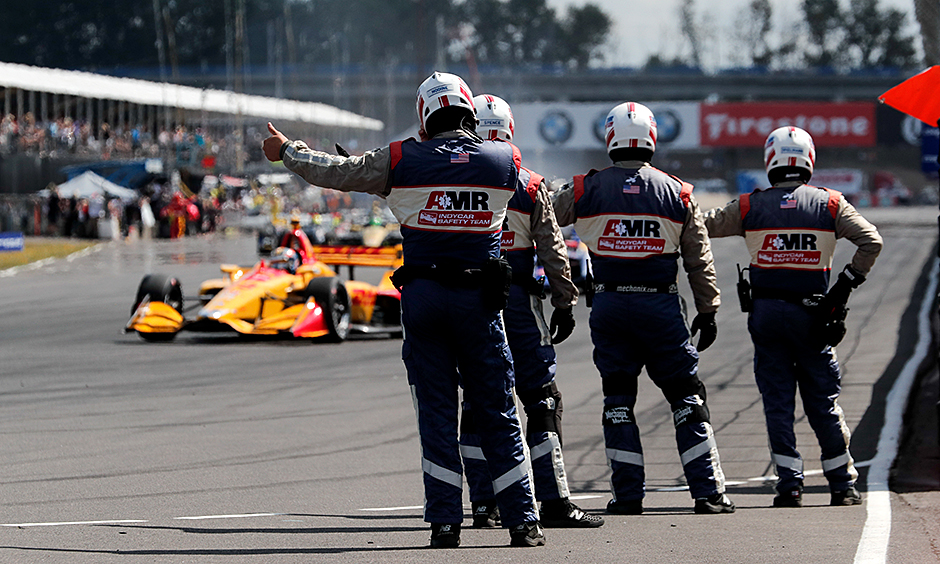 AMR INDYCAR Safety Team members wish the drivers good luck at the start of the Portland Grand Prix.