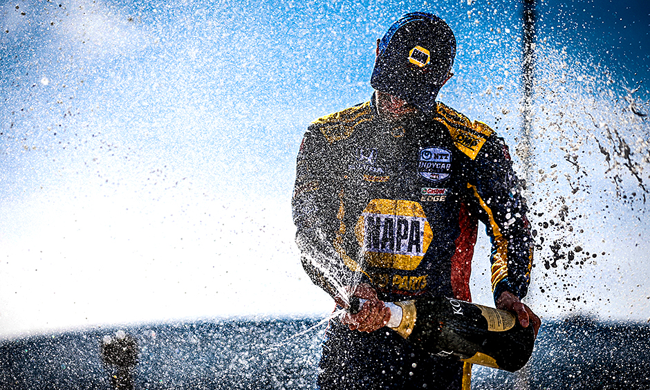 Alexander Rossi celebrates a win by spraying champagne.